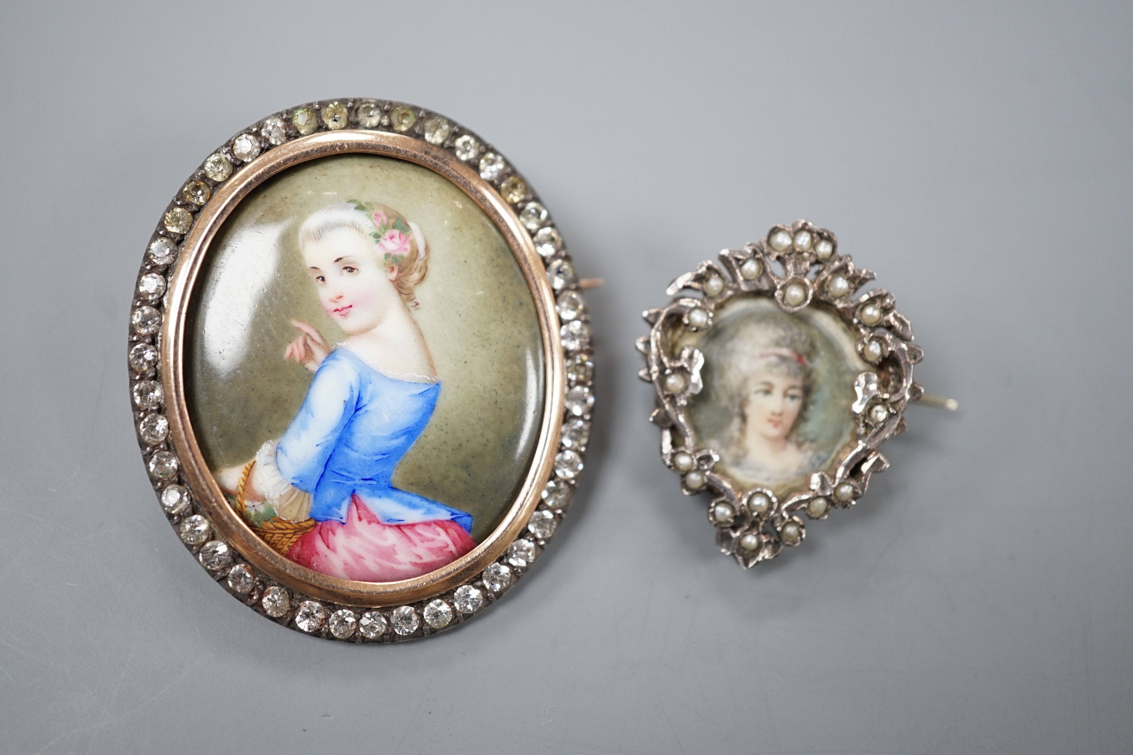 A Victorian yellow and white metal and paste set oval miniature brooch, 41mm and a small circular seed pearl set miniature brooch.